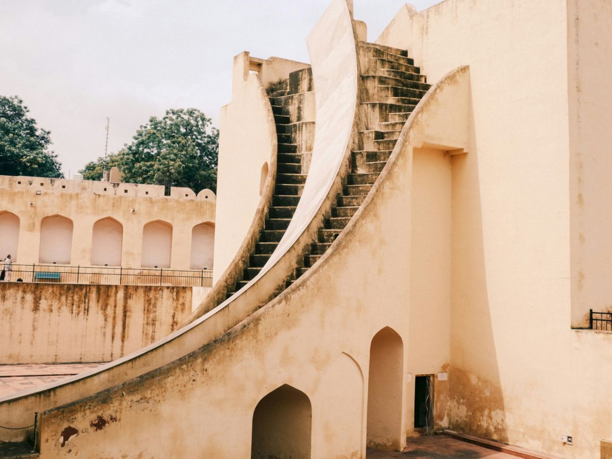 An architectural structure with curved steps, part of the Jantar Mantar observatory in Jaipur, showcasing its unique historical design.